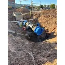 Installation of a pipe underground at a construction site.