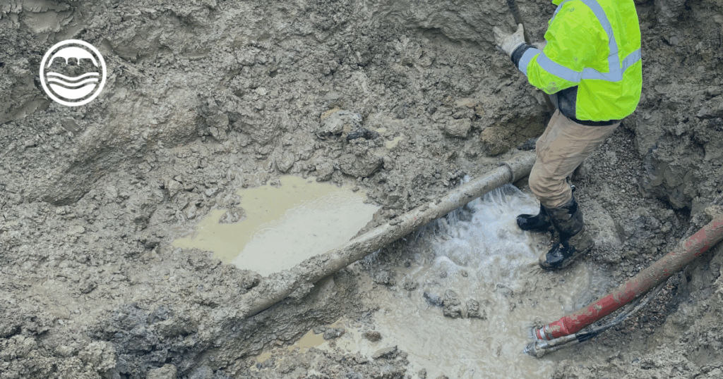 Operations crew working on a 4 inch concrete main dig out and leaking water